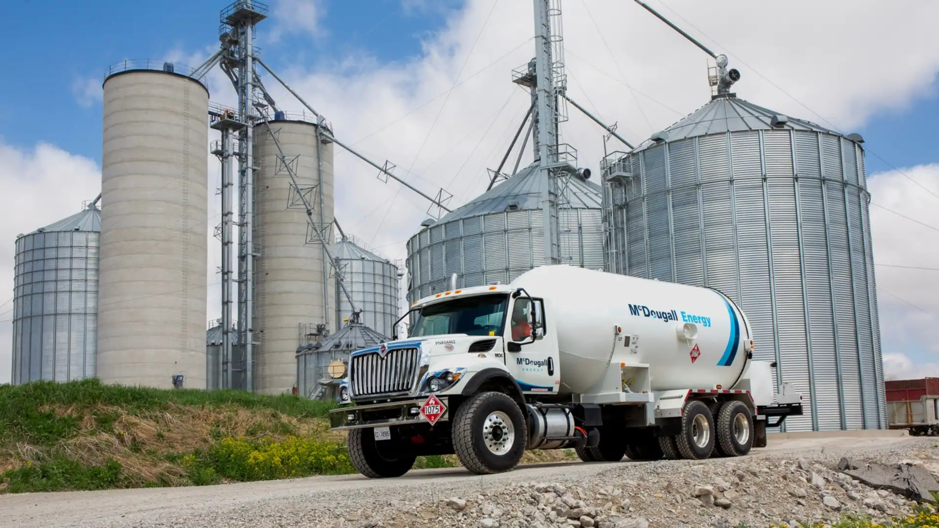 Fuel delivery truck at grain storage silos for McDougall Energy.