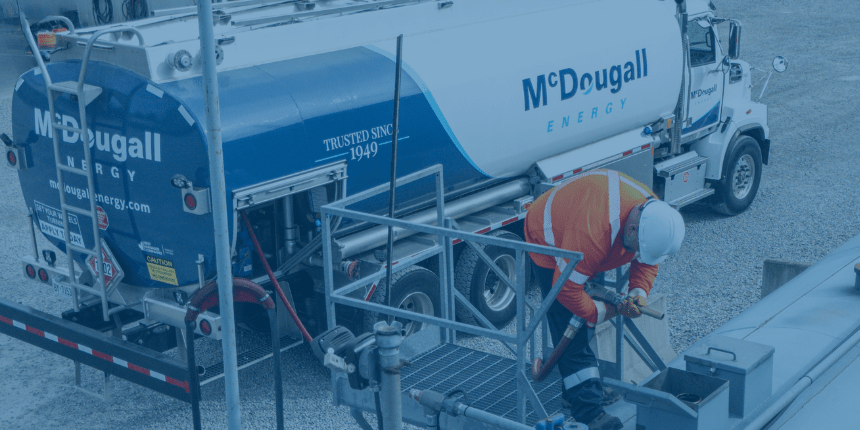 McDougall Energy fuel truck driver safely fuelling up a bulk tank