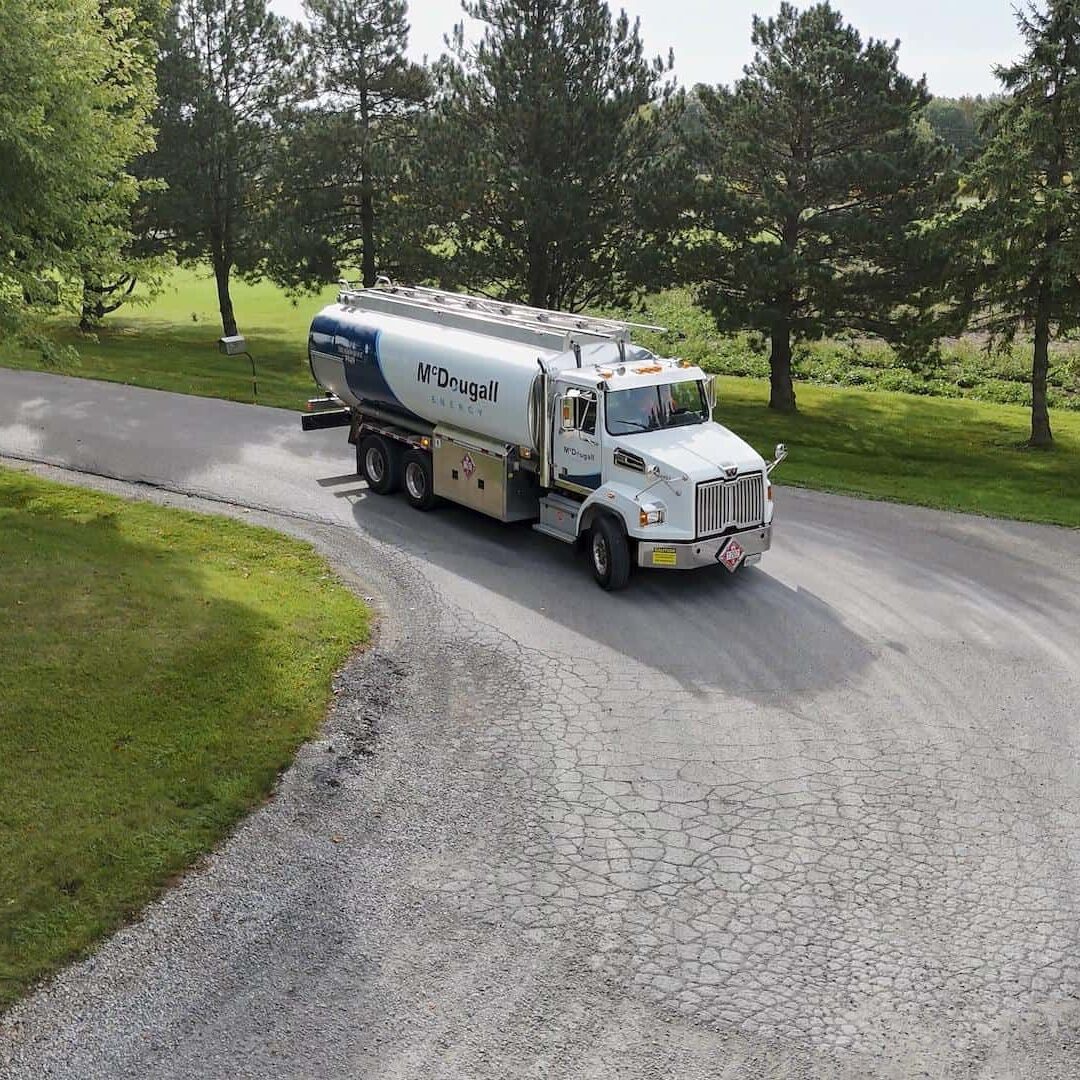 Oil delivery truck from McDougall Energy on a rural road.